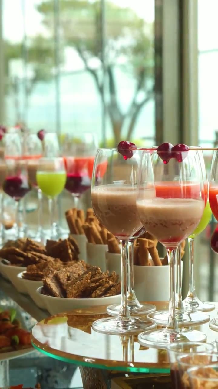 Video: a guest lifting a cherry-garnished drink from a reception table