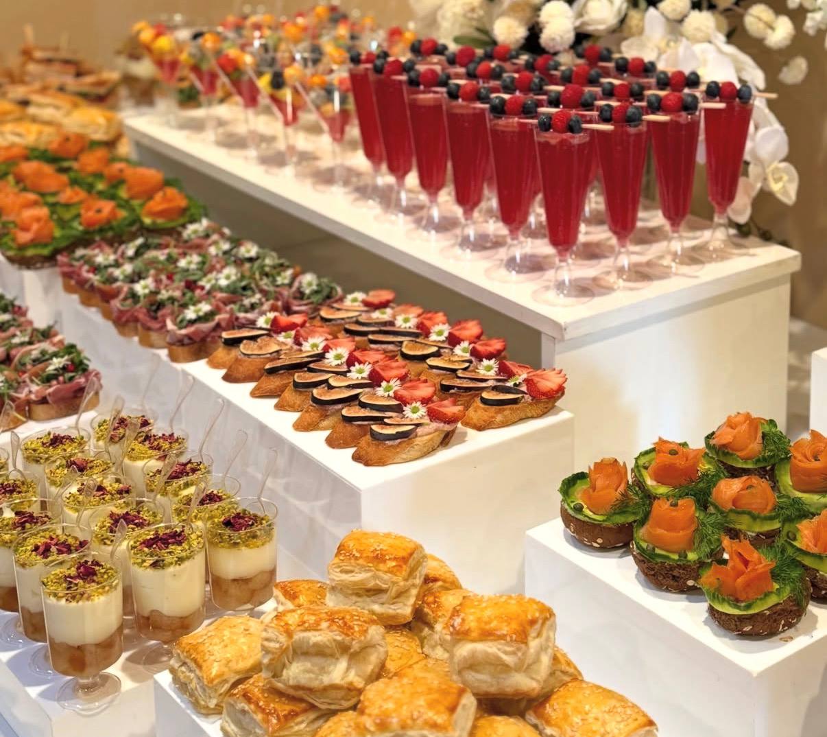 Long buffet tables of fig and berry crostini, smoked salmon and berry champagne flutes
